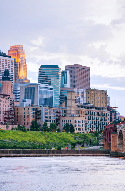 Downtown Minneapolis, Minnesota at night time as seen from the famous stone arch bridge